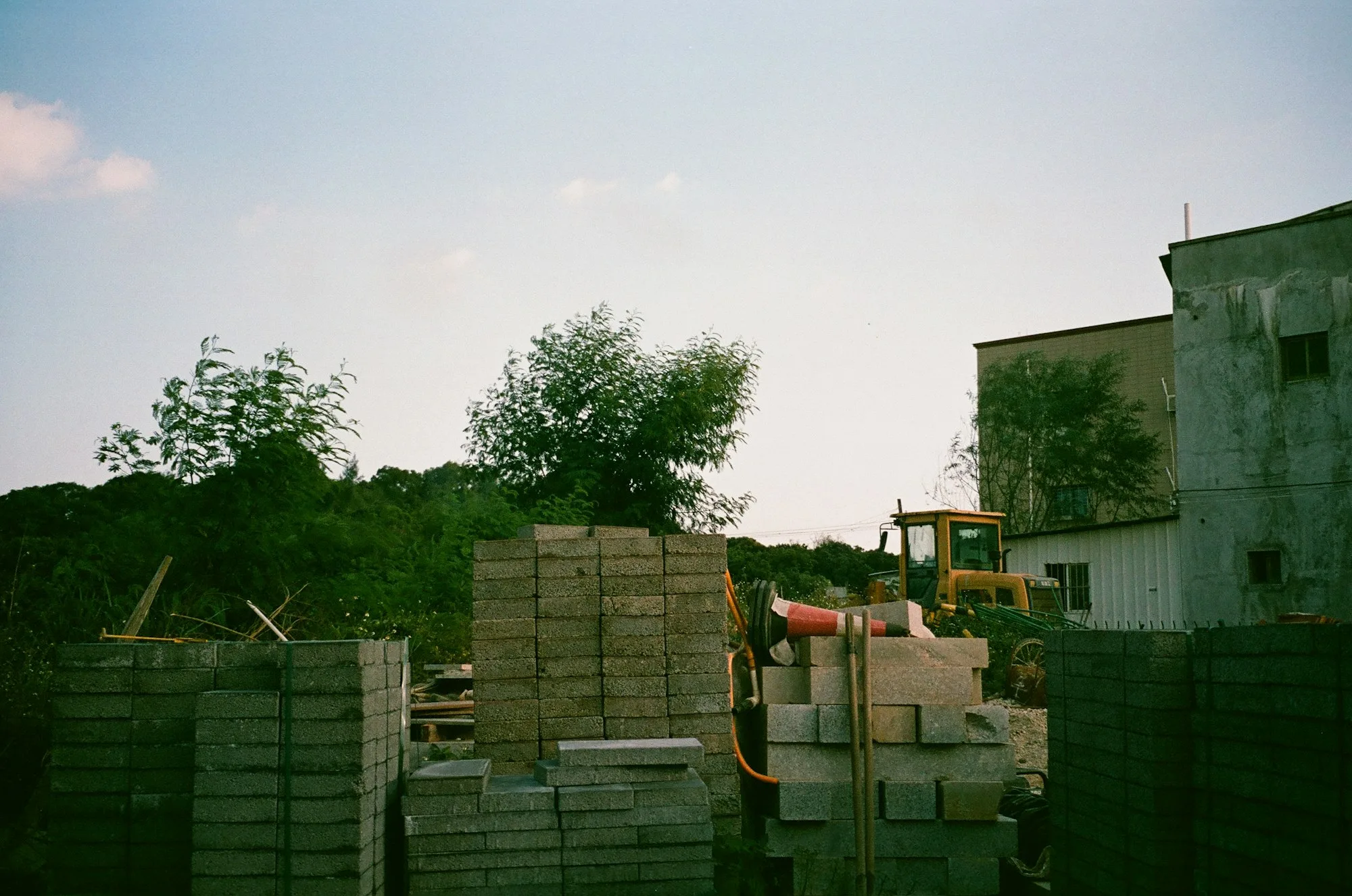 Construction site with stacked blocks and earth-moving machinery